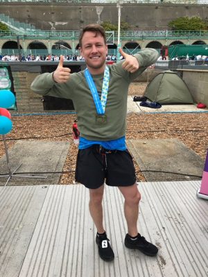 Dan Simon giving the thumbs up after completing the 2018 Brighton Marathon.