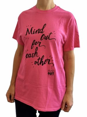 figure wearing pink tshirt with black logo reading "mindout for each other"