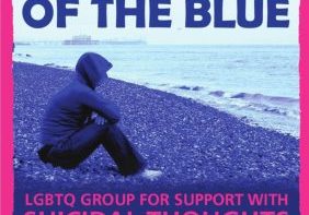 out of the blue poster showing person with hoodie on sitting on pebbles looking out to see