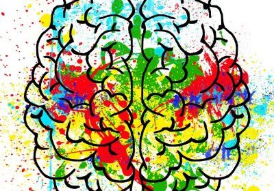 illustration of a brain with brightly coloured paint splashed and splattered around and across it