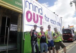 volunteers and staff beside the MindOut bus before it sets off for the parade